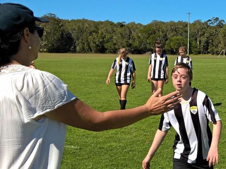 Marc Stillhard high fives and opposition coach as he leaves the field after a game of football with the Yamba under-14 team.