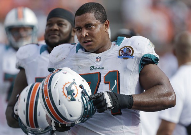 In this Dec. 16, 2012, file photo, Miami Dolphins tackle Jonathan Martin stands on the sidelines during the Dolphins' NFL football game against the Jacksonville Jaguars in Miami. Prosecutors say the former lineman has pleaded not guilty to threatening former teammates who had harassed him in the NFL. Los Angeles County prosecutors say Martin appeared in court Tuesday, March 20, 2018, and pleaded not guilty to charges of making criminal threats and carrying a loaded firearm.  (AP Photo/Wilfredo Lee, file)