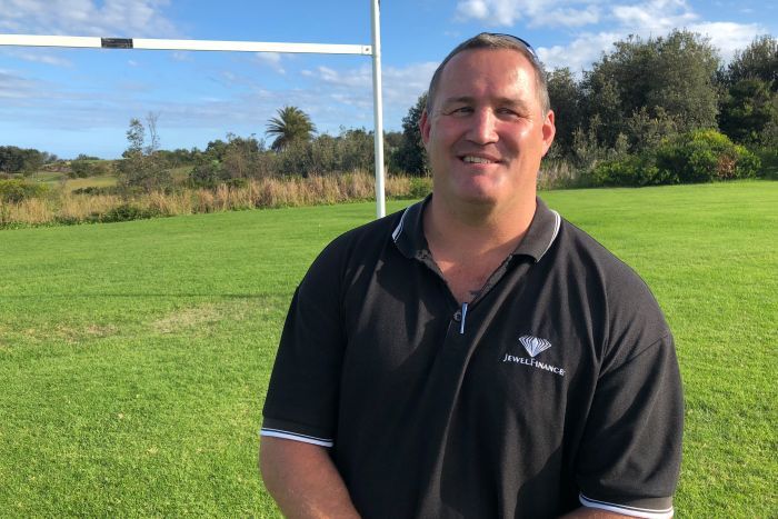 Former North Sydney Bears player Josh Stuart standing in front of a rugby league post on a field