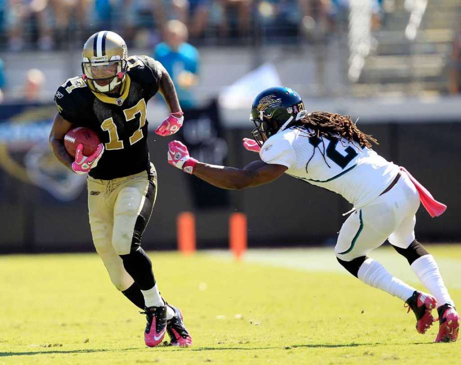 FILE - Rashean Mathis #27 of the Jacksonville Jaguars attempts turnover tackle  Robert Meachem #17 of the New Orleans Saints during a game at EverBank Field on Oct. 2, 2011 in Jacksonville, Fla. Federal prosecutors say Meachem fell victim to a Houston woman accused of stealing more than $1 million from him. Photo: Sam Greenwood, Getty Images / 2011 Getty Images