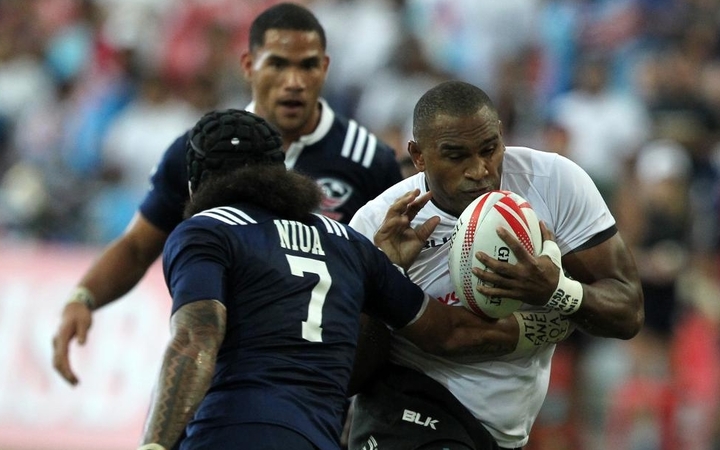 Isake Katonibau of Fiji charges forward against USA at the Singapore Sevens.