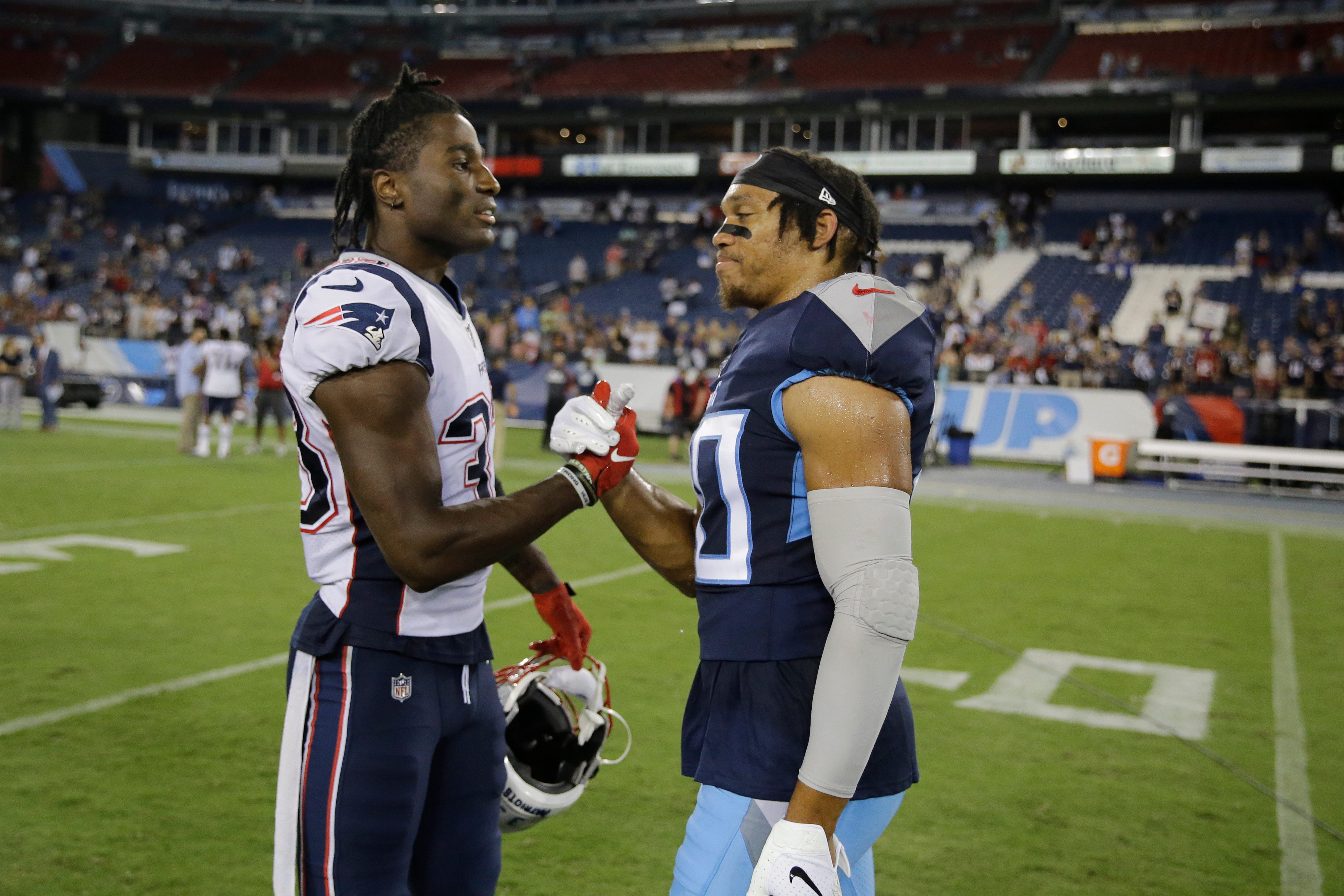 New England Patriots cornerback Joejuan Williams, left, talks with Tennessee Titans defensive back LaDarius Wiley, on Aug. 17, 2019. Both are former Vanderbilt players.