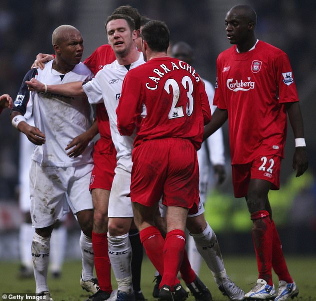 Diouf (left) squares up to his former Liverpool team-mate Jamie Carragher while at Bolton