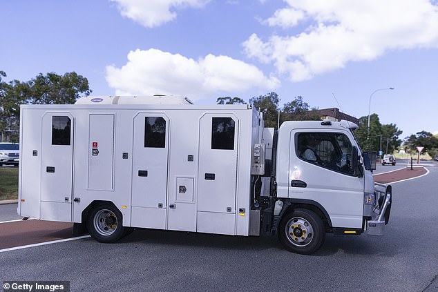 Cousins was placed in a holding cell at the Perth watch house and will face Armadale Magistrates Court on Thursday. Pictured: Van believed to be transporting Cousins is seen leaving court