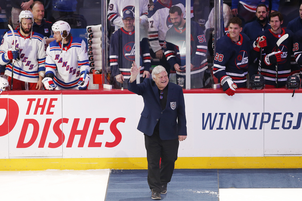 Bobby Hull waves to the crowd during a ceremony honouring Thomas Steen and Randy Carlyle by the Winnipeg Jets Hall of Fame before a Jets home game in February.