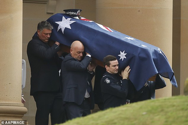 The coffin of Constable Josh Prestney is carried from Xavier College in Melbourne last Monday. It was the same day the Dean Laidley scandal wiped the tragic police funerals from opening the news