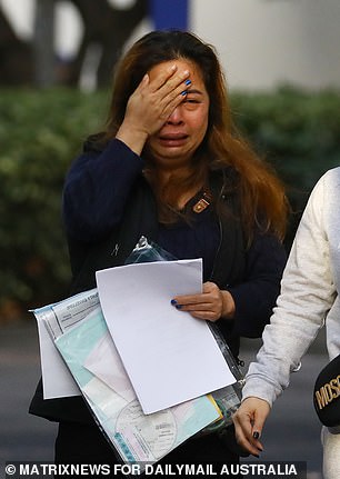 Charged: Former Vietnamese cake shop owner turned alleged baby formula racket player Tram Phan, 41, sobs as she is released from police custody on Wednesday