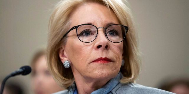 In this Feb. 27, 2020, file photo, Education Secretary Betsy DeVos pauses as she testifies during a hearing of a House Appropriations Sub-Committee on the fiscal year 2021 budget on Capitol Hill in Washington.  