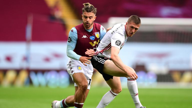 BIRMINGHAM, ENGLAND - JUNE 17: John Lundstram of Sheffield United is challenged by Jack Grealish of Aston Villa during the Premier League match between Aston Villa and Sheffield United at Villa Park on June 17, 2020 in Birmingham, England. (Photo by Shaun Botterill/Getty Images)